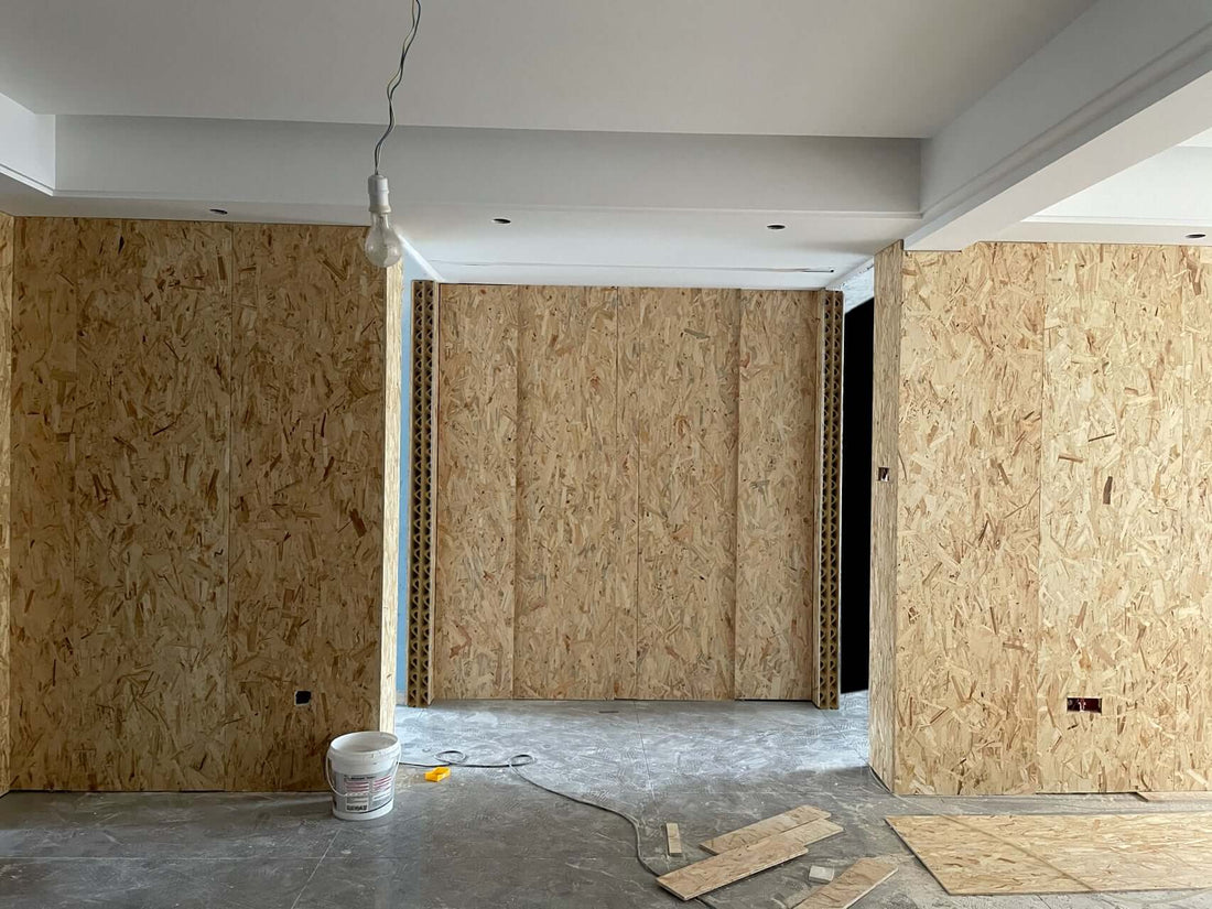 Natural Fibre Board room partition under construction, showcasing lightweight honeycomb core structure and installation process.